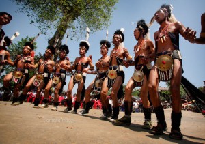 Chang Naga tribe / tribal warriors / men in traditional dress tribal jewelry and handloom textiles singing and dancing at Moatsu festival of sowing , Chuchuyimlang village , near Mokokchung , Nagaland , North East Frontier States , India Pic: Copyright Timothy Allen / Axiom